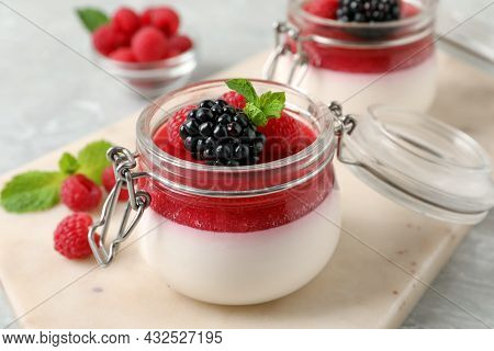 Delicious Panna Cotta With Fruit Coulis And Fresh Berries On Light Table