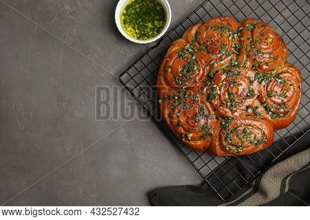 Traditional Ukrainian Garlic Bread With Herbs (pampushky) And Aromatic Oil On Grey Table, Flat Lay. 