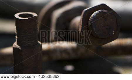 Old Rusty Bolt, Iron Rod With Screw Threads. Rusted Mechanical Components. Threaded Bolt And Nut. Di