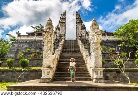 Woman Traveler At Ancient Gate At Pura Penataran Agung Lempuyang Temple On Bali, Indonesia