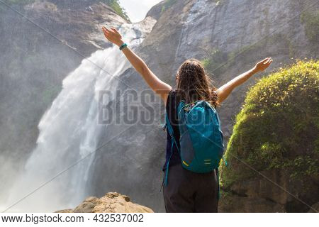 Woman Tourist And Dunhinda Waterfall In A Sunny Day In Sri Lanka