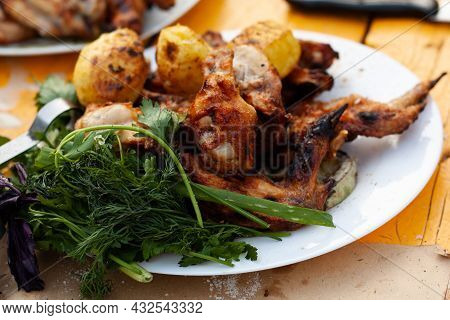 Chicken Kebab With Potatoes And Herbs On A Plate