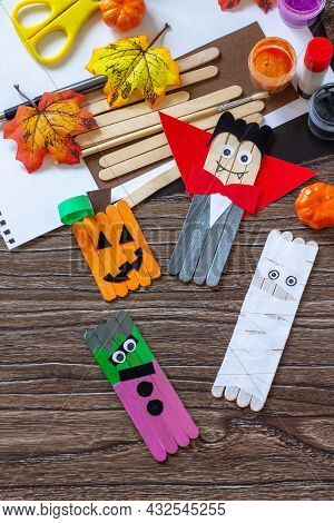 Halloween Ghost, Pumpkin, Mummy And Vampire Toy Gift Stics Puppets On Wooden Table. Handmade. Projec