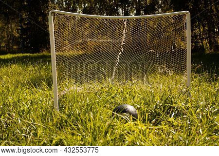 Football Goal And Football Ball On The Green Grass