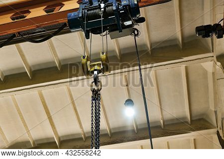 The Chains For Lifting Loads On The Telpher Crane Lie On A Wooden Rack.