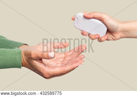 People sharing alcohol spray for personal hygiene in the new normal