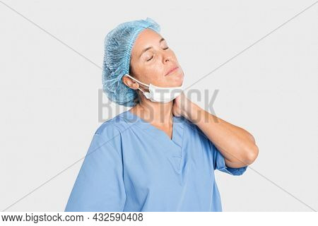 Tired female surgeon in a blue gown