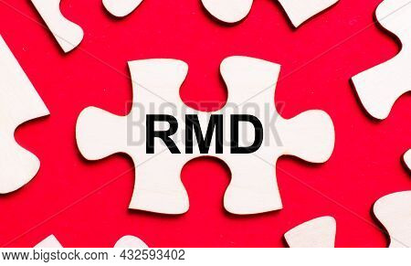 On A Bright Red Background, White Puzzles. In One Of The Pieces Of The Puzzle, The Text Rmd Required