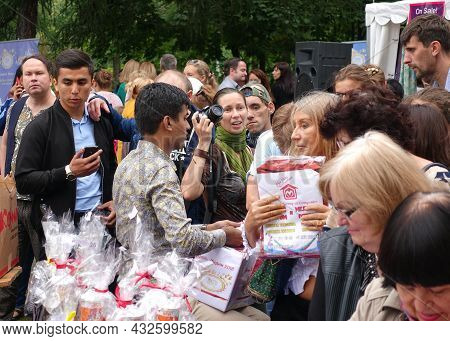 Moscow, Russia, August 14, 2016: A Man At A Street Market In A Summer Park Sells Indian Goods . Agio