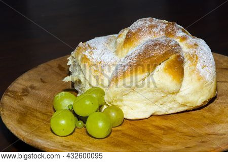 Sweet Cake With Grape On A Wooden Platter