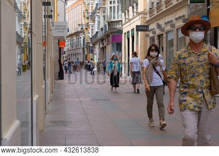 Málaga, Spain - June 19, 2021: People Walking In The Historic Center Of Malaga In Spain