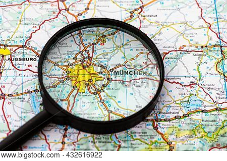 Map Of Munchen In Germany Through Magnifying Glass, Concept Of Planning The Travel Itinerary