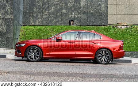 Side View Volvo S60 Red Color Third Generation Model In Front Of Granite Tiled Wall. Moscow, Russia 