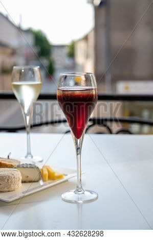 Drinking Of Kir Royal,  French Aperitif Cocktail Made  From Creme De Cassis Topped With Champagne, T