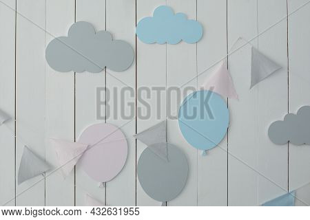 White Wall Is Decorated With Multi-colored Garland Of Flags And Air Ballons. Decor For Holiday. Styl