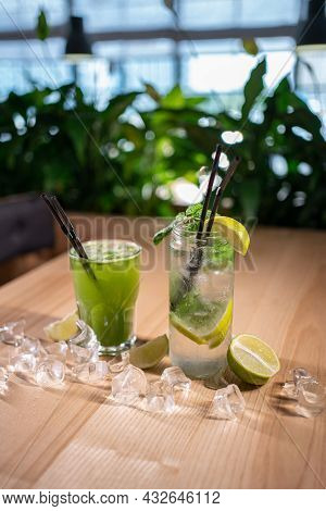 Mojito With Mint, Lime And Ice In Glass And Green Tarkhun Tarragon Drink In Cafe