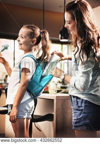 Happy family preparing for school. Little girl with mother