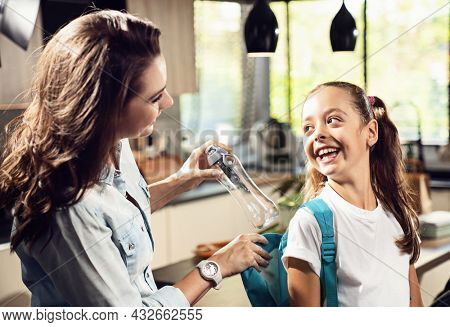 Happy family preparing for school. Little girl with mother