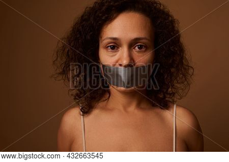 Close Up Portrait. Frightened Desperate Mixed Race Woman With Sealed Mouth Looking At Camera With Ho