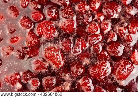 Process Of Making Homemade Strawberry Jam. Red Sweet Syrup Boiling On The Stove Closeup. Strawberry 