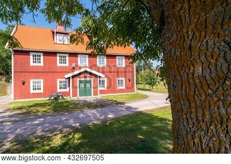 Vastervik, Sweden - 08.23.2021: Typical Red Wooden Countryside House In Nature Of Southern Sweden On