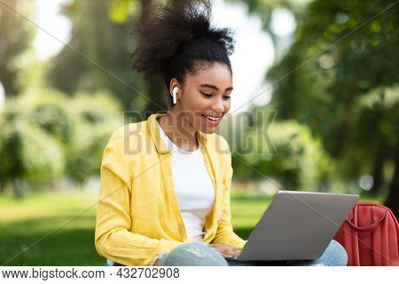 Black Student Girl Talking To Laptop Webcam During Webinar Outdoor