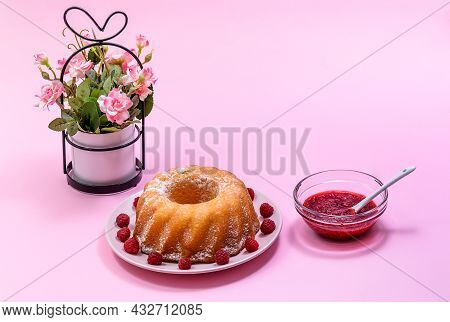 Homemade Kouglof Cake With Icing Sugar Dressing, Raspberries And Raspberry Filling. Gugelhupf, Kugel