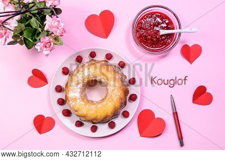 Homemade Kouglof Cake With Icing Sugar Dressing, Raspberries And Raspberry Filling. Gugelhupf, Kugel