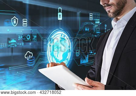 Businessman In Formal Suit Is Touching Tablet With His Hand. Office Workplace In Background. Digital