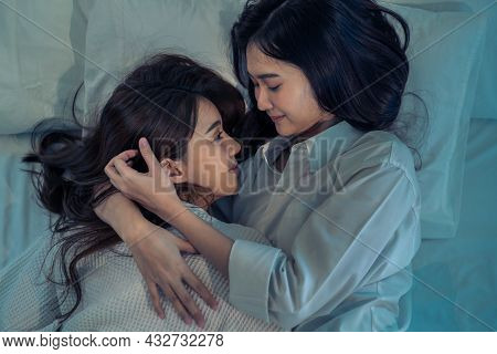 Asian Beautiful Lesbian Couple Lying Down On Bed And Hugging Each Other. Attractive Romantic Girl Fr