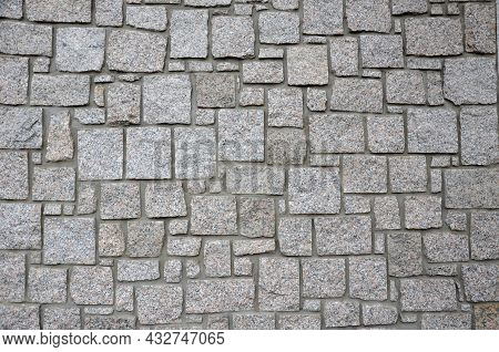 Irregular Cyclopean Masonry On The Wall Of A House Or Cottage. Gray Granite Is Cut Into Cube Shapes 