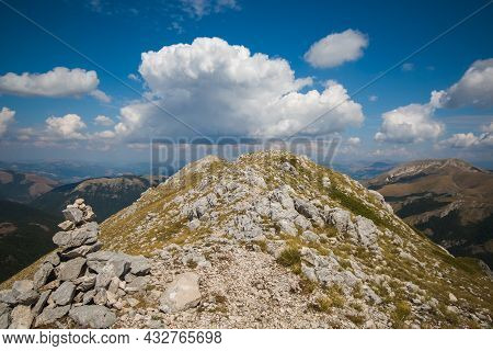 A Pile Of Stones (also Called Cairn, Steinmännchen Or Steinmandl) In The Peak Of Italian Apennines W