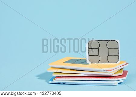 Different Sim Cards On Light Blue Background. Space For Text