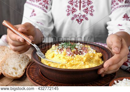 Woman Eating Banosh With Brynza And Pork Cracklings At Wooden Table, Closeup. Traditional Ukrainian 
