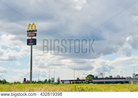 Mcdonald Logo On Board Against Blue Sky. Mcdonalds Banner At Mcdrive Cafe. Katy Wroclawskie, Poland 