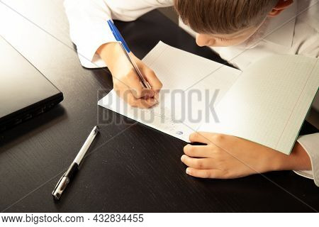 Close-up Of A Child Writes In A Notebook.
