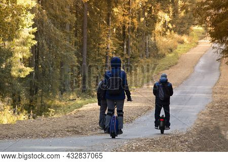Monowheel.people Ride A Monowheel In The Autumn Park.
