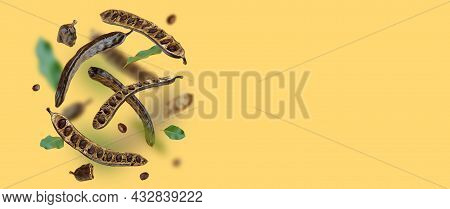 Creative Composition. Floating Organic Carob Pods, Seeds, Leafs. Food Background. Natural Vegan Eati