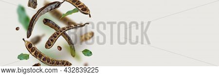 Creative Composition. Floating Organic Carob Pods, Seeds, Leafs. Food Background. Natural Vegan Eati