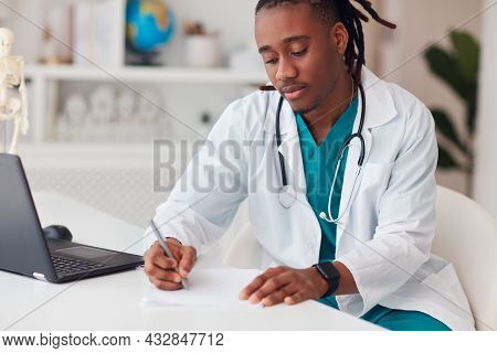 Young African American Doctor With Tracheostomy Scar Filling Paper Documentation