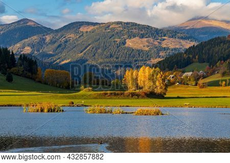 autumn pond under the mountains, Murau district,
Styria, Austria
