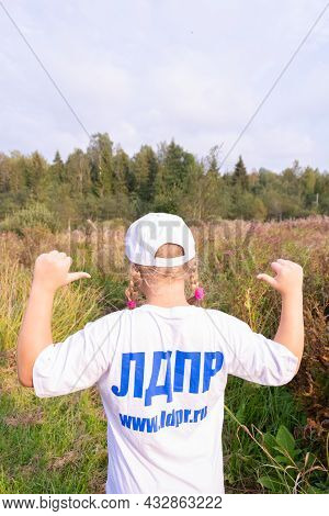 Russia - August 27, 2021. Tver Region. A Girl In A White Cap And A T-shirt With The Inscription \