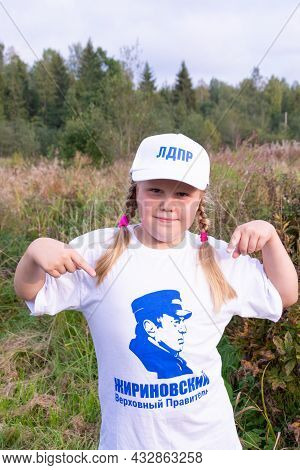 Russia - August 27, 2021. Tver Region. A Girl In A White Cap And A T-shirt With A Photo Of Vladimir 