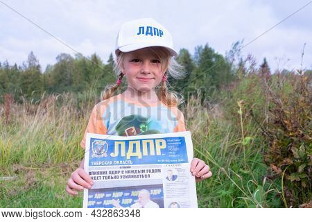 Russia - August 27, 2021. Tver Region. A Girl In A White Cap With The Inscription \