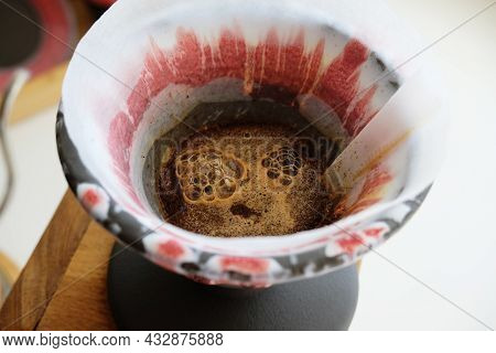Freshly Roasted Coffee Blooming In Pottery Craft Ceramic Clay Dripper V60. Specialty Coffee Concept.