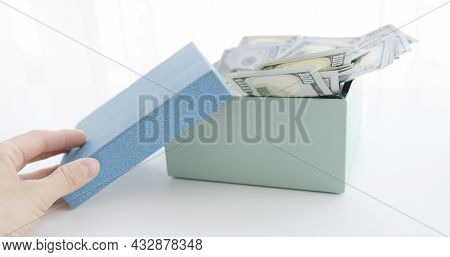 Gift Box With Banknote Of Dolla And Hand.