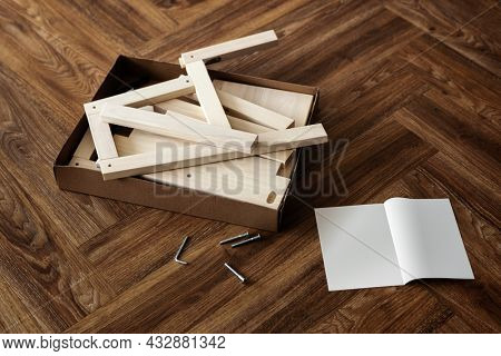 Ready-to-assemble chair and instruction book on the floor