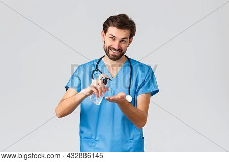 Healthcare Workers, Pandemic And Coronavirus Outbreak Concept. Smiling Man Showing How To Use Hand S