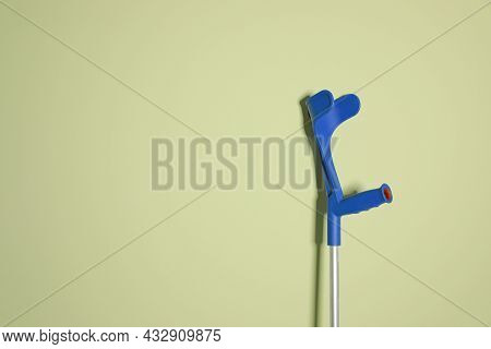 Elbow Crutch On Light Green Background. Space For Text