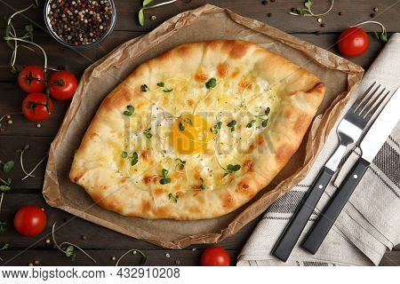Fresh Delicious Adjarian Khachapuri Served On Wooden Table, Flat Lay